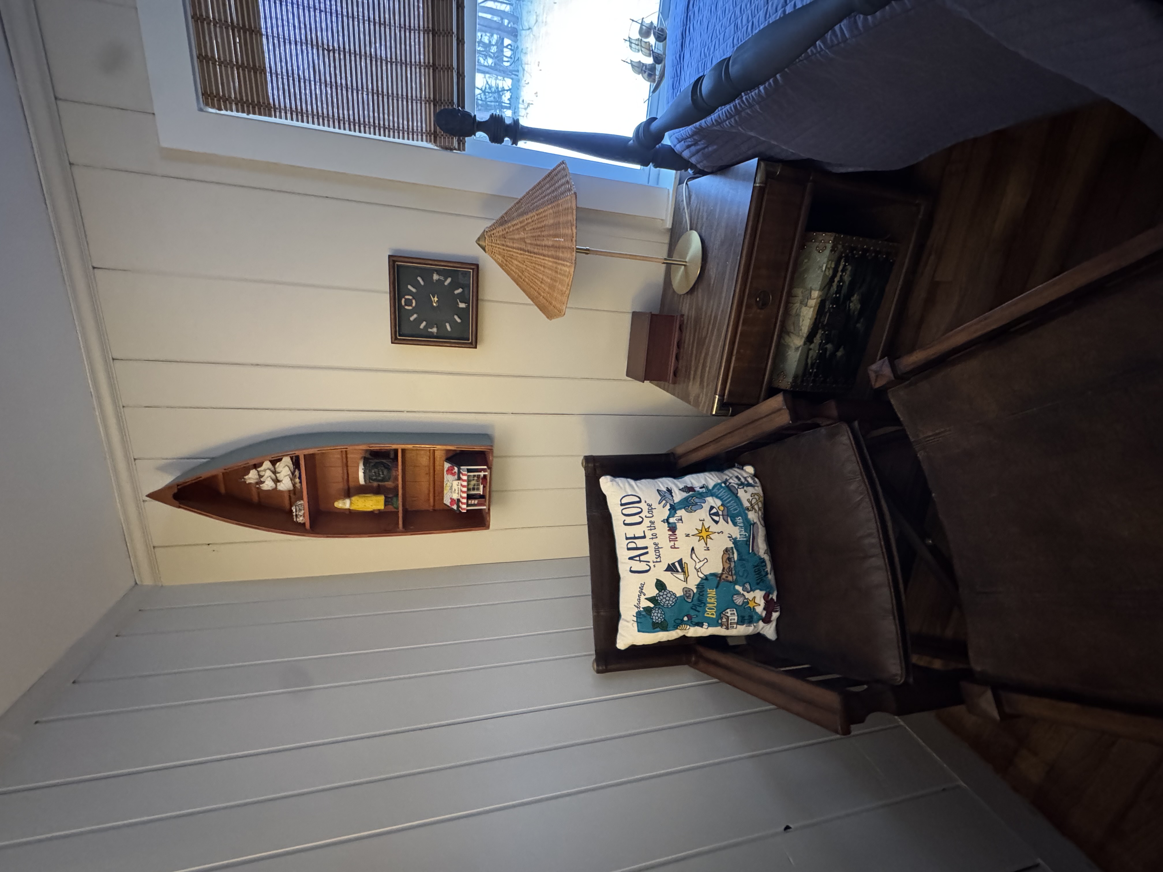 Cozy reading corner with Cape Cod pillow and boat shelf